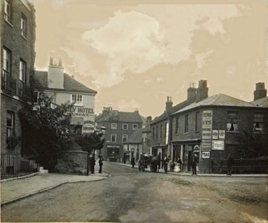 Looking north around 1900 to the beginning of the High Street from what is now the central reservation of the pedestrian crossing at the end of Hampton Court Way.